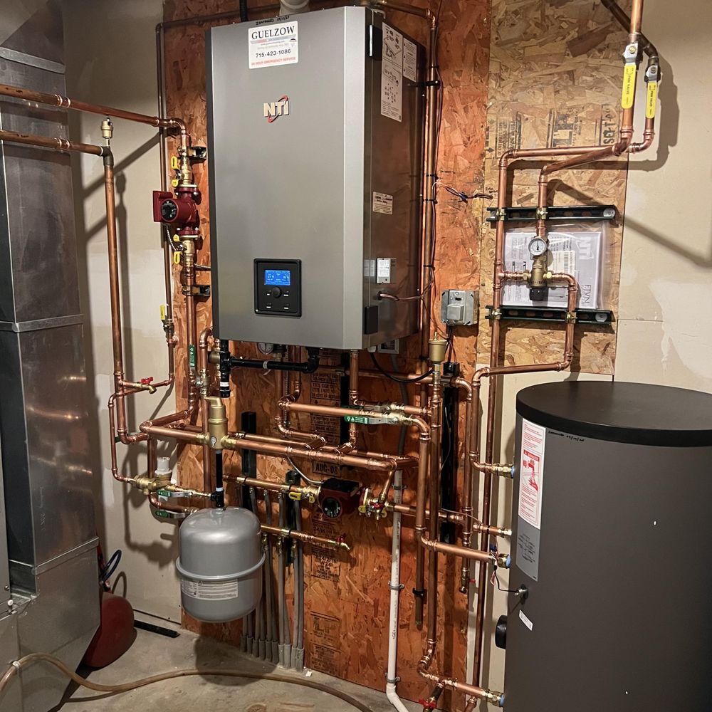 Technician carefully checking water heater venting, valves, and tank condition for safety